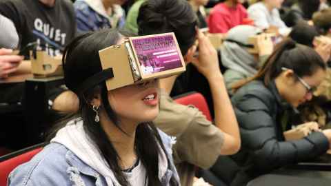 Photo of a student wearing a Google Cardboard virtual reality viewer