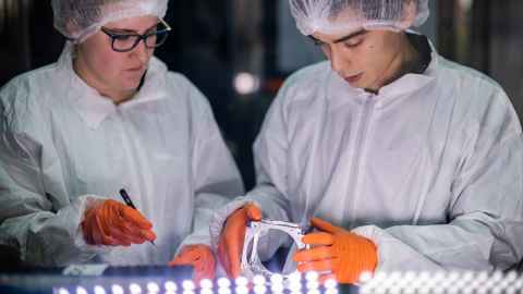 APSS students Emma Doolin and Aryan Lobie with a CubeSat in our cleanroom.