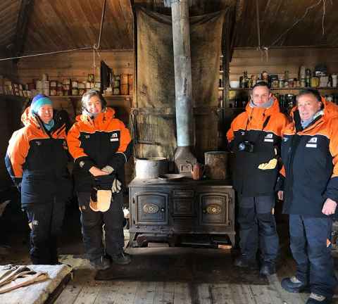 Juliet Gerrard (second from left) in Antarctica inside Shackleton's Hut Antarctica.