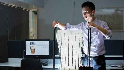 Dr Peng Du, with torso-shaped rig for recording the bioelectrical activity of the gut from the body surface
