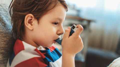 Child using an asthma inhaler