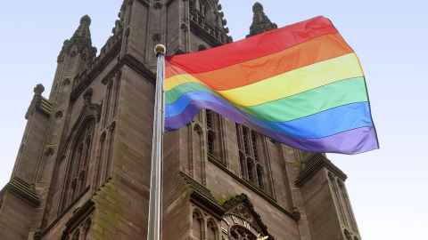 Rainbow flag flying outside a church