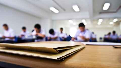 Pictured is an examination room of school students: Not returning to an entirely-exam based system is a welcome feature of the NCEA review, says Dr Aaron Wilson.