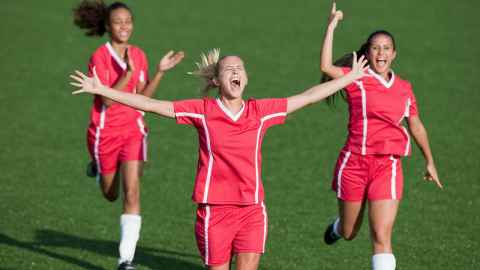 Exuberant female footballers are pictured celebrating goal success: but such celebrations by a victorious US FIFA World Cup team brought criticism that Professor Toni Bruce believes would never be applied to male teams. Photo: iStock