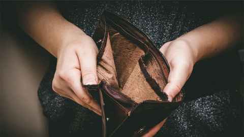 Person holding an empty wallet open.