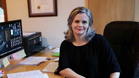 Billie Bradford sitting at an office desk