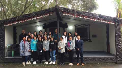 A group of students from China standing outside the Marae at the Epsom Campus.
