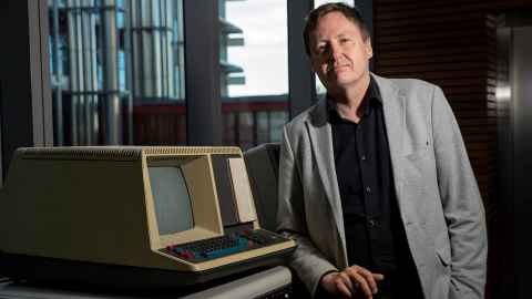 Professor Michael Witbrock, head of the Broad AI Lab, with a 1980s Digital Equipment Corp terminal. 