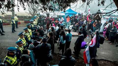 Protestors and police are pictured at Ihumātao. Photo: Julie Zhu Photography