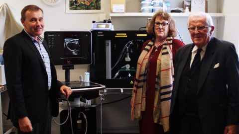 Professor Julian Paton, Anne Chamley and Jim Chamley standing next to the Vevo 3100 machine.