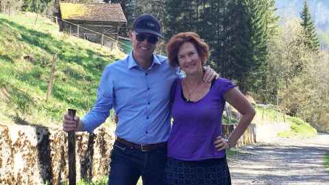 Richard Sorrenson and Professor Helen Sword with their arms around each other and standing on a rural road.