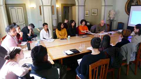 Professor Mignolo and fifteen students seated around a table in Old Government House