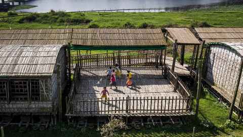 Children playing in a fenced courtyard in an Arcadia Education Project.
