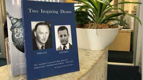 The book "Two Inspiring Deans" displayed on a counter