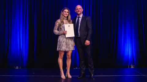 Maxine Cooper holding an award certificate