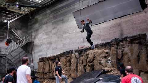 Riley Phillips-Harris jumping off a cliff in an indoor movie set.
