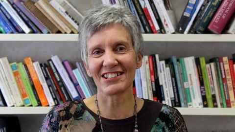 Professor Niki Harre in front of some bookshelves