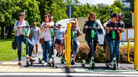 A group of E-scooters users wait to cross the road. Photo: iStock-scooters users in Christchurch. Photo: iStock 
