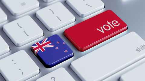 A computer keyboard with one of the keys replaced by a New Zealand flag and the Enter key replaced by the word "Vote"
