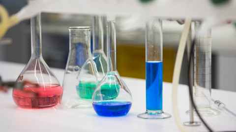 Lab glassware containing red, green and blue liquids