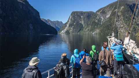 Tourists to NZ are photographed looking out onto the beauty of Doubtful Sound, one of the visitor attractions of Fiordland. Photo: iStock