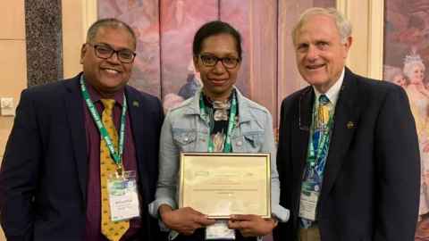 Nirmal Nair, Leonie Bule with her award, and Frank Lambert