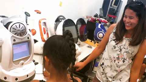 Two young women working on robots