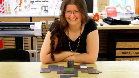 Annabelle Collins with gaming pieces on the table in front of her