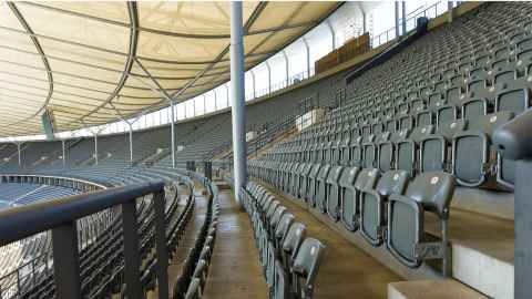 An image shows empty seating across a large stadium. Photo: Achim Scholtya, Pixabay