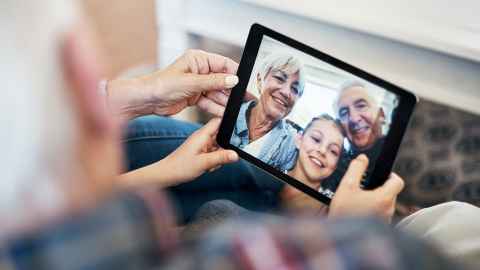Image of several generations communicating via an iPad