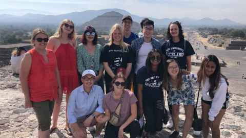 A group of students, some wearing University of Auckland t-shirts