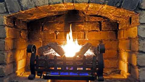 A cosy fire burns in a brick grate: Anecdotal evidence suggests many affluent superannuitants don't notice the Winter Energy Payment increase on their NZ Super. Photo: iStock