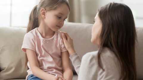 A mother is pictured talking to an anxious young girl: Saying goodbye may be hard for you and your young child when schools open on Monday – but your relationship will be key to easing the return to normality. Photo: iStock