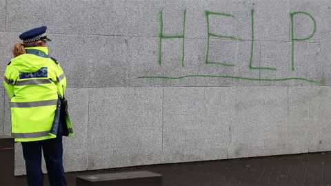 The image show the word 'Help' written on the Beehive wall on the day of a protest against uplifts of Maori children by Oranga Tamariki. Social work is increasingly about cost-effective discipline of the disadvantaged, writes Ian Hyslop. Photo: Lynn Grieveson, Newsroom