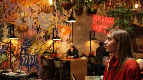 Georgia Arnold admires the mural that she created after winning the Snickel Lane Urban Art Award.