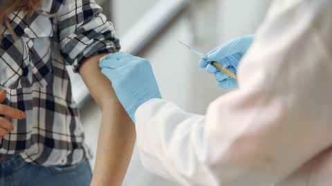 A healthcare worker giving an injection to a patient.