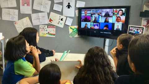 A group of children looking at a screen.
