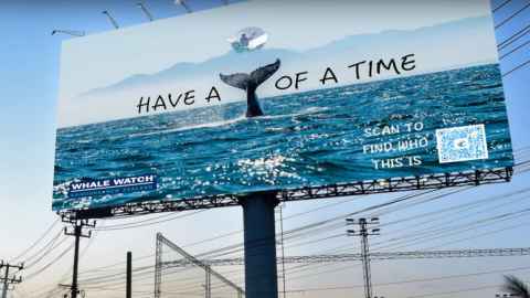 A billboard with the words 'Have a', an image of a whale's tail and the words 'of a time'.