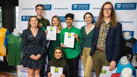 A group of people, some holding certificates.