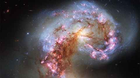 The photo shows a NASA image of the Antennae Galaxies. Photo: Creative Commons -BY 4.0 NASA/ESA
