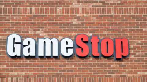 The image shows a GameStop shop sign on a brick wall: The real takeaway from the trading frenzy over GameStop is the surging undercurrent of frustration driving WallStreetBets to enter the fray in the first place. Photo: iStock