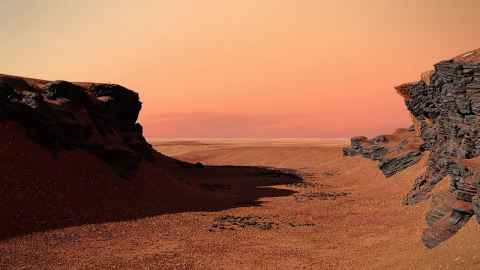 Red ground against a red sky.
