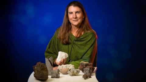 Professor Jan Lindsay holding some volcanic rocks.