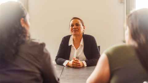 The image shows a female business leader at the table: Diversity at leadership level should improve a board’s ability to make well-informed decisions. Photo: iStock