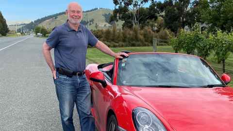 Emeritus Professor Colin Green Professor with one of his favourite sports cars, a red Porsche.