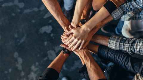 Putting in a semi-circle, putting their hands together.