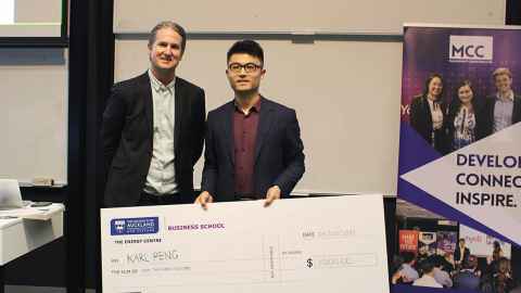 Two men with a giant cheque.