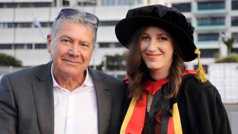Lauren Donnan in graduation regalia with dad Rob.