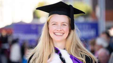 Hanna Davidson in graduation regalia.