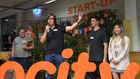 Four people standing in Unleash Space, one with a microphone.